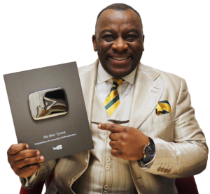 Gordon Hurd aka Big Man Tyrone holding YouTube silver plaque